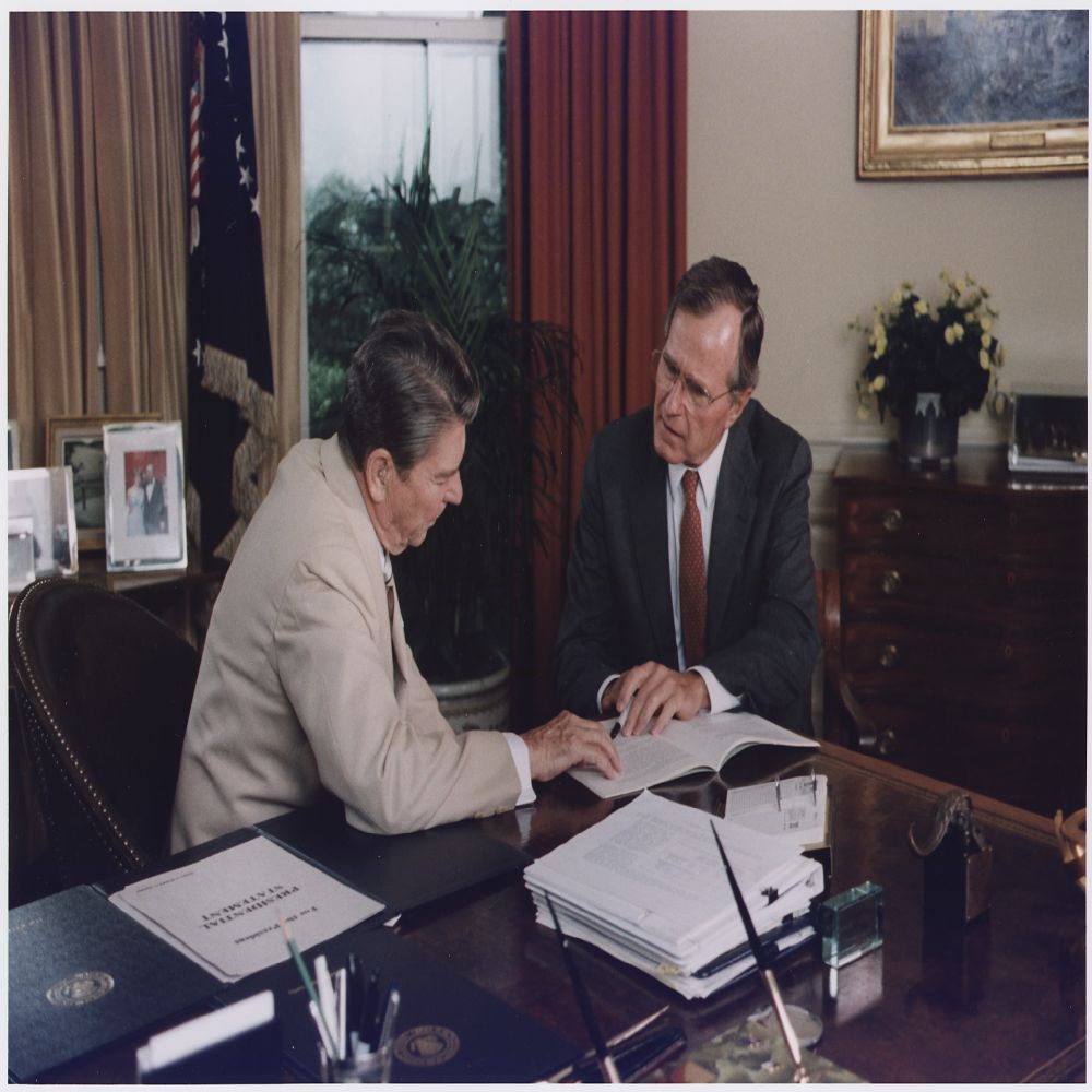 Vice President Bush and President Reagan working in the Oval Office